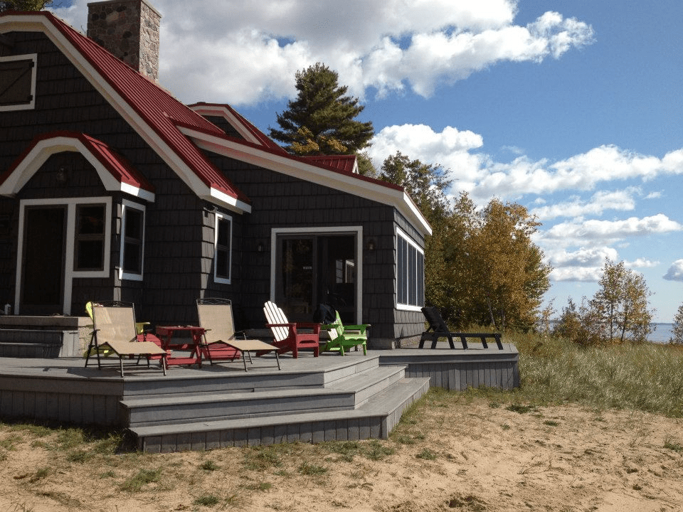 Small House with Grey Siding, White Windows, and Red Roof: A Perfect Blend of Style and Comfort