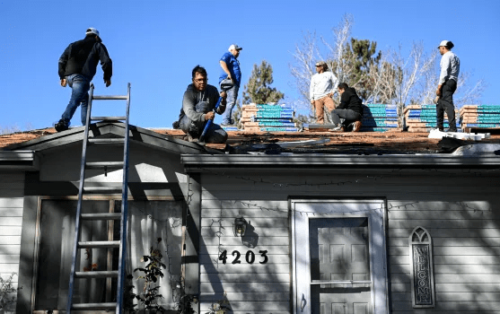 A Group Of People Putting A Roof On A House: Essential Steps and Considerations for a Successful Roof Installation