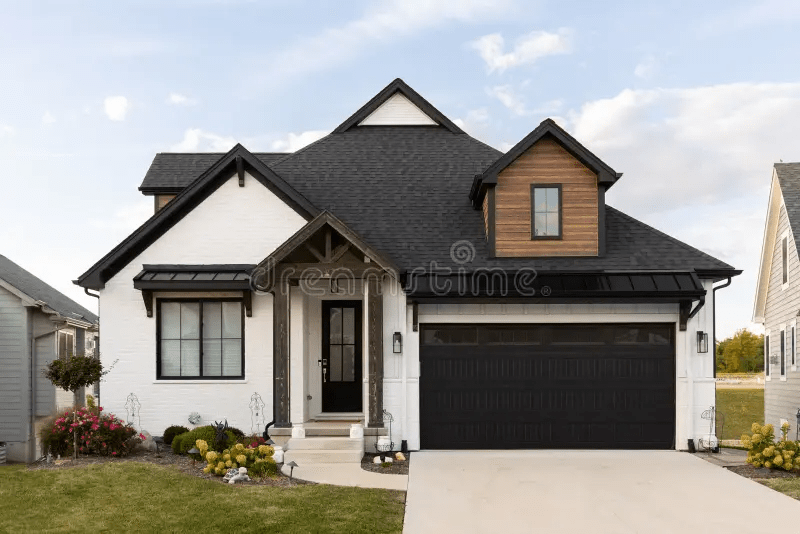 White Coach Style House With Brown Brick and Black Roof