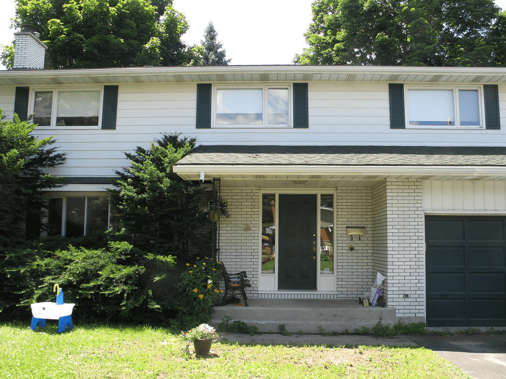 White House With Green Roof Different Color Shutters And Door