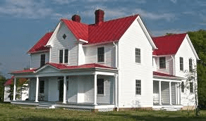 Pic Of White Ranch House W/ Maroon Metal Roof
