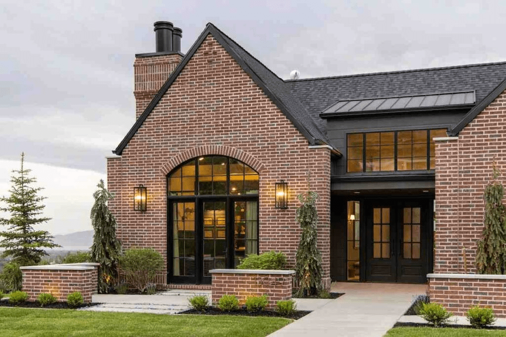 Red Brick House With Black Roof And Black Gutters